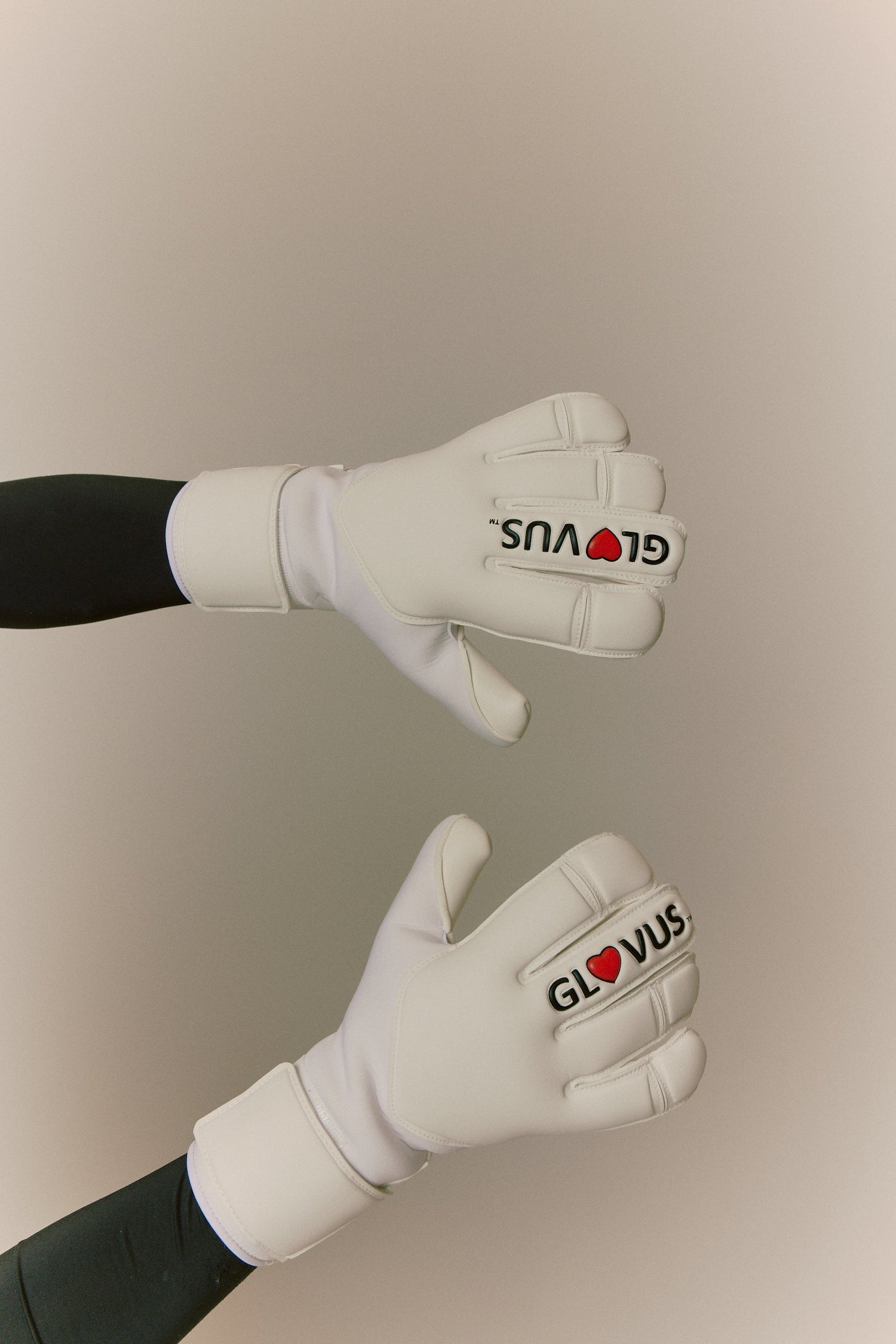 White gloves with visible branding on a neutral background